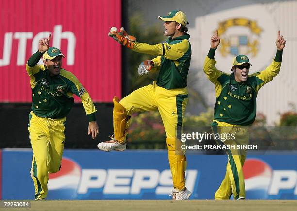 Australia cricketer Adam Gilchrist celebrates the caught behind of India cricketer Sachin Tendulkar with captain Ricky Ponting and teammate Michael...