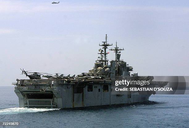 Helicopter hovers above American assault war ship USS Boxer LHD 4 as it manoeuvres during the ninth Indo-US joint excercise 'Malabar-2006' in the...