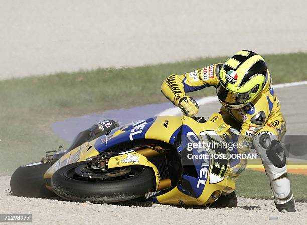 Italy's Valentino Rossi tries to right his bike after skidding off the track during the GP race at the Valencia Grand Prix at the Ricardo Tormo...