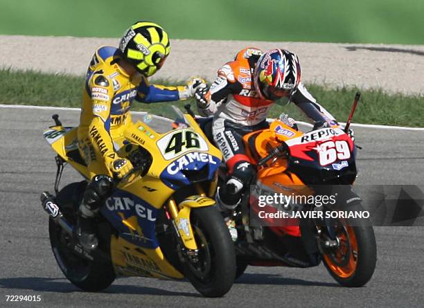 Italy's Valentino Rossi congratulates US Nicky Hayden after winning the 2006 Moto GP championship at the end of season Valencia Grand Prix at the...