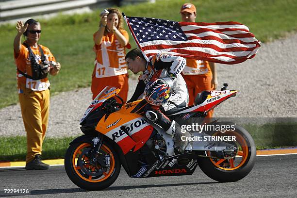 Nicky Hayden does a victory lap after winning the 2006 Moto GP championship at the end of season Valencia Grand Prix at the Ricardo Tormo racetrack...
