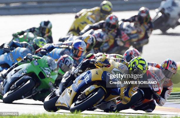 Italian Valentino Rossi powers his Yamaha ahead followed by US nicky Hayden during the MotoGP race at the Valencia Grand Prix at the Ricardo Tormo...