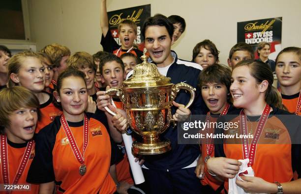 Roger Federer of Switzerland pictured with the ball children after winning the mens final of the ATP Davidoff Swiss Indoors Tournament at...