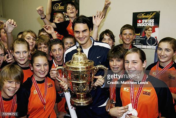 Roger Federer of Switzerland pictured with the ball children after winning the mens final of the ATP Davidoff Swiss Indoors Tournament at...