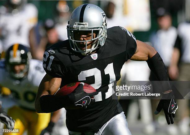 Nnamdi Asomugha of the Oakland Raiders runs with the ball on an interception for a touchdown against the Pittsburgh Steelers on October 29, 2006 at...