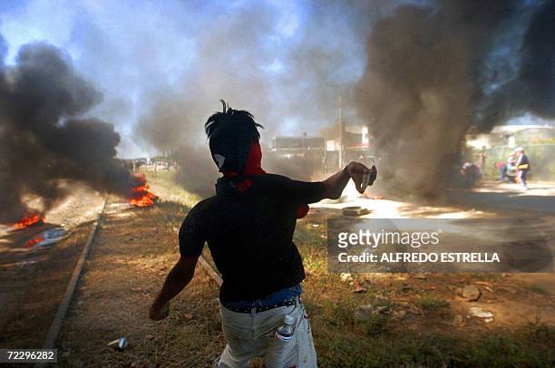 Member of the People?s Popular Assembly throws stones to the Federal Police during clashes in the outskirts of Oaxaca, Mexico, 29 October 2006....