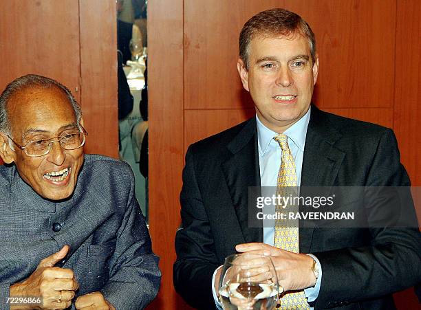 Britain's Prince Andrew, The Duke of York, a Special Representative for International Trade and Investments shares a light moment with former Indian...