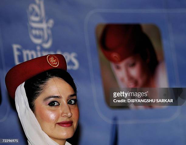 Member of the cabin crew of Emirates Airline looks on during a press conference in Bangalore, 30 October 2006. Emirates Airline is currently...