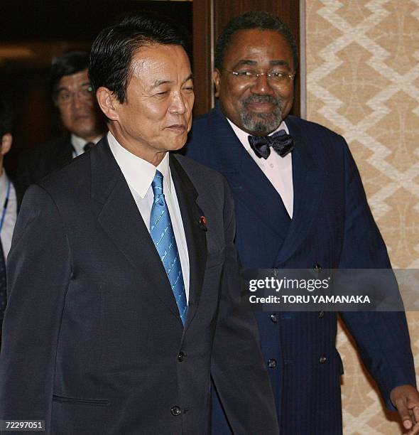 Japanese Foreign Minister Taro Aso leads his Congolese counterpart Rodolphe Adada upon his arrival at the Iikura guesthouse in Tokyo, 30 October...