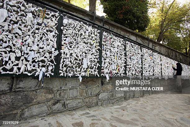 Visitor ties a piece of paper onto a wish wall at the house of Virgin Mary near the Ephesus, 95 kms from the western coastal city of Izmir, 29...