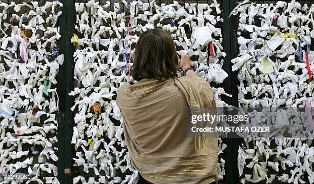 Visitor ties a piece of paper onto a wish wall at the house of Virgin Mary near the Ephesus, 95 kms from the western coastal city of Izmir, 29...