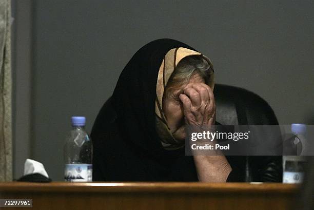 Kurdish witness Esha Hama Amin pauses during her testimony during the ongoing trial of former Iraq President Saddam Hussein inside the heavily...