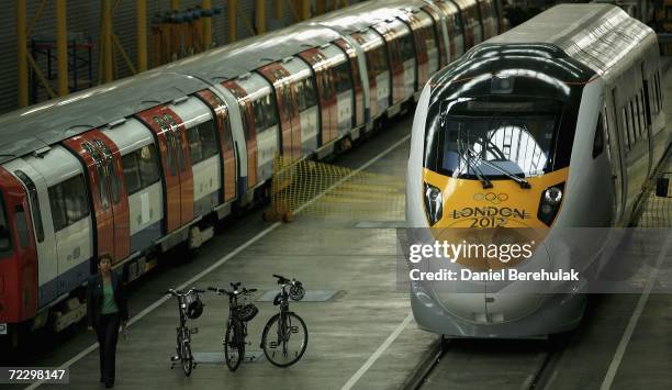 Member of the press walks past a prototype of the new high speed Javelin train and the other modes transport for the 2012 Olympics on October 30,...