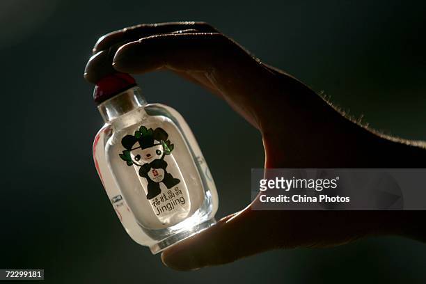 Interior painting artist Li Junyu displays his artwork inside of a snuff bottle October 30, 2006 in Xian of Shaanxi Province, China. The patterns...