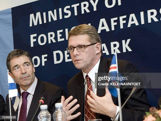 Prime Minister Matti Vanhanen, Finland, flanked by the host, Denmark 's Prime Minister Anders Fogh Ramussen, gestures at a press conference 30...