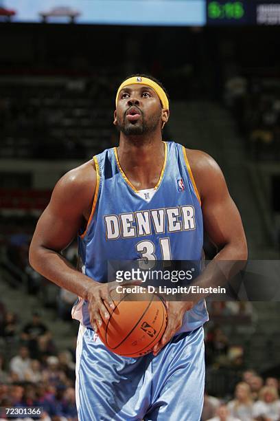 Nene of the Denver Nuggets prepares to shoot a free throw during the preseason game against the Detroit Pistons at The Palace of Auburn Hills on...