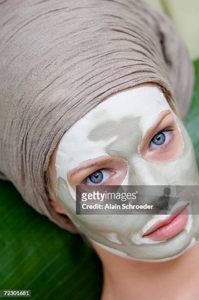 young woman face with beauty mask - clay mask ストックフォトと画像