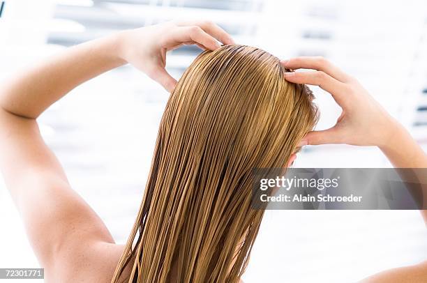 young woman with wet hair, view from the back, close up (studio) - women massage stock-fotos und bilder