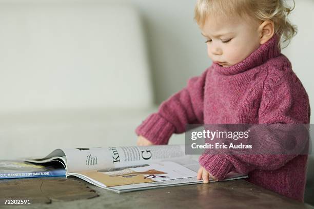 little boy reading a magazine - baby attitude stock pictures, royalty-free photos & images