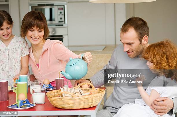 couple and 2 little girls at breakfast table - kid boiled egg stock pictures, royalty-free photos & images