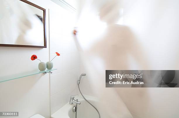 woman taking a shower, view through shower curtain - shower curtain stock pictures, royalty-free photos & images
