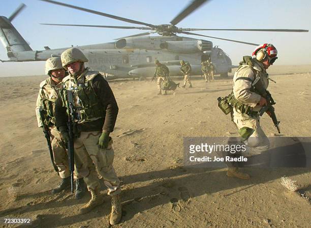 Marines and U.S. Army 10th Mountain Division soldiers depart from the Super Stallion helicopter to begin setting up the Forward Arming Refueling...