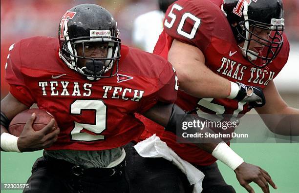 Ricky Williams of the Texas Techs Red Raiders grips the ball as he moves during a game against the Missouri Tigers at Jones Stadium in Lubbock,...