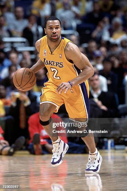 Guard Derek Fisher of the Los Angeles Lakers dribbles the ball during the NBA game against the Houston Rockets at the Staples Center in Los Angeles,...
