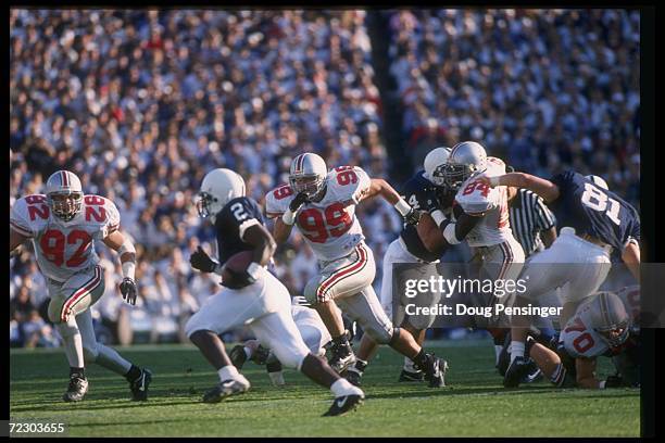 Defensive lineman Luke Fickell of the Ohio State Buckeyes pursues a Penn State Nittany Lions player during a game at Beaver Stadium in University...