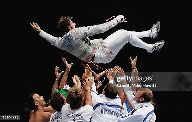 Aldo Montano of Italy is tossed in the air as he celebrates his victory in the men's fencing individual sabre gold medal bout on August 14, 2004...