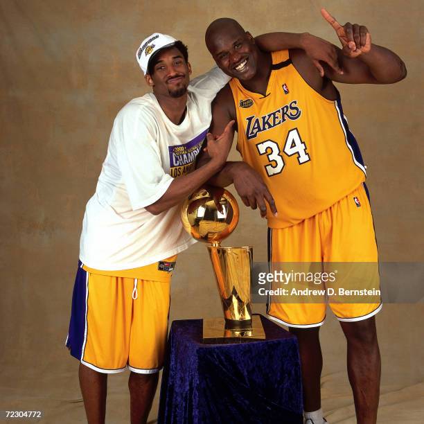 Kobe Bryant and Shaquille O''Neal#34 of the Los Angeles Lakers pose for a portrait with the Championship Trophy after defeating the Indiana Pacers in...