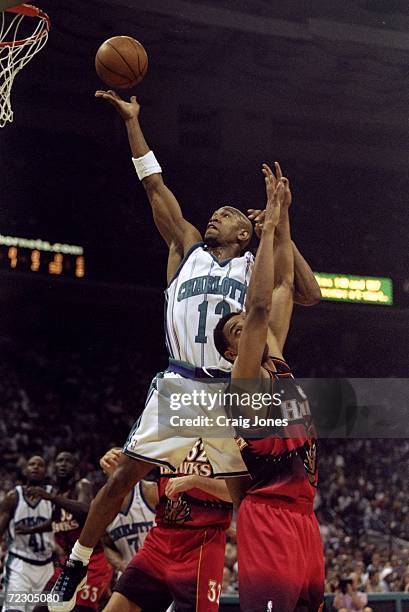 Bobby Phills of the Charlotte Hornets drives to the basket over members of the Atlanta Hawks during a first round Playoff Game at the Charlotte...