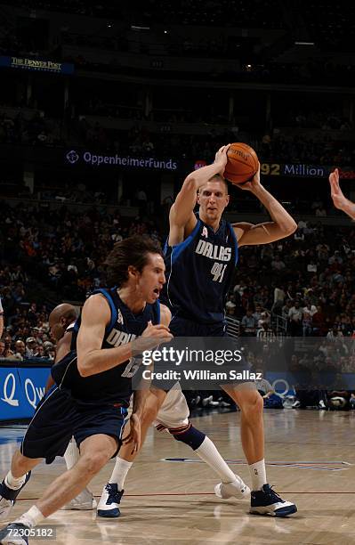 Center Dirk Nowitzki of the Dallas Mavericks holds the ball as teammate, guard Steve Nash, runs during the NBA game against the Denver Nuggets at the...