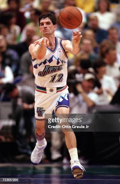 John Stockton of the Utah Jazz passes the ball during a game against the Dallas Mavericks at the Delta Center in Salt Lake City, Utah. The Mavericks...