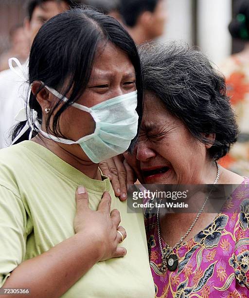 People mourn the loss of members of their family March 31, 2005 in Gunungsitoli on the Island of Nias, Indonesia after a massive earthquake struck...