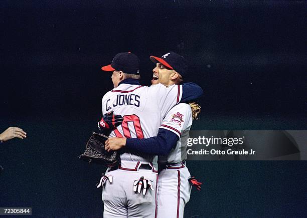 David Justice of the Cleveland Indians is congratulated by Chipper Jones after catching the game ending fly ball to win game four of the World Series...