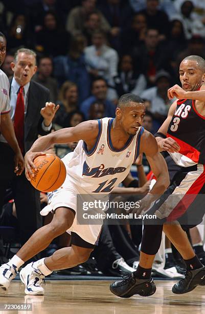 Guard Chris Whitney of the Washington Wizards dribbles the ball around point guard Damon Stoudamire of the Portland Trail Blazers during the NBA game...
