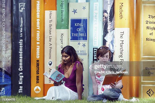 Sue Amaradivakara and Sarah Ross sit reading in front of some giant books at "The Guardian Hay Festival 2004" held at Hay on Wye on May 30, 2004 in...
