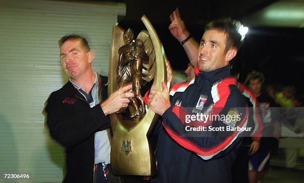 Coach Michael Hagan and captain Andrew Johns of the Knights arrive with the trophy as the Knights arrive at Marathon Stadium to celebrate after the...