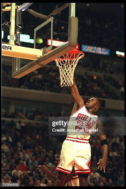 Guard Michael Jordan of the Chicago Bulls does a slam dunk to the joy of the crowd at the United Center in Chicago, Illinois during the game against...