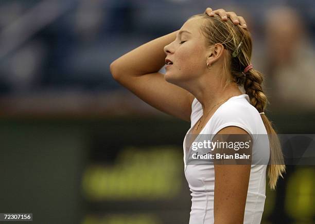 Fourteen-year-old Maria Sharapova of Russia reacts after missing an easy slam against Monica Seles of the USA during the Pacific Life Open at the...