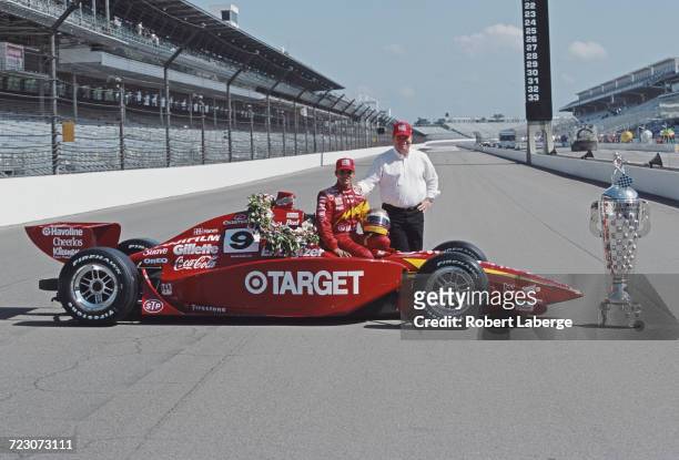 Juan Pablo Montoya of Colombia and team owner Chip Ganassi stand beside the Target Chip Ganassi Racing G-Force GF05a Oldsmobile and the Borg Warner...