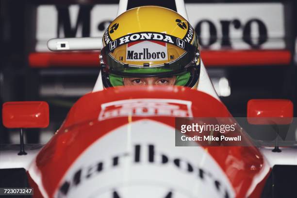 Ayrton Senna of Brazil sits aboard the Honda Marlboro McLaren McLaren MP4/6 Honda V12 during practice for the Iceberg United States Grand Prix on 9...
