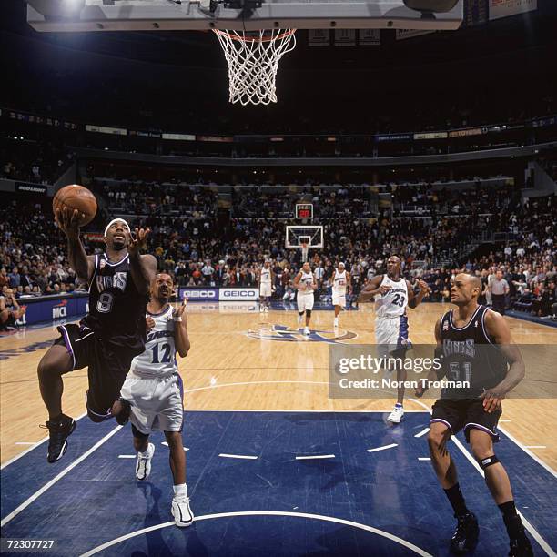 Point guard Mateen Cleaves of the Sacramento Kings shoots the ball as guard Chris Whitney of the Washington Wizards plays defense during the NBA game...