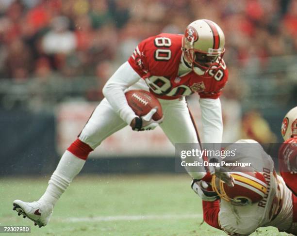 Wide Receiver Jerry Rice of the San Fransisco 49ers tries to free himself from the grip of Washington Redskins safety Stanley Richards during the...