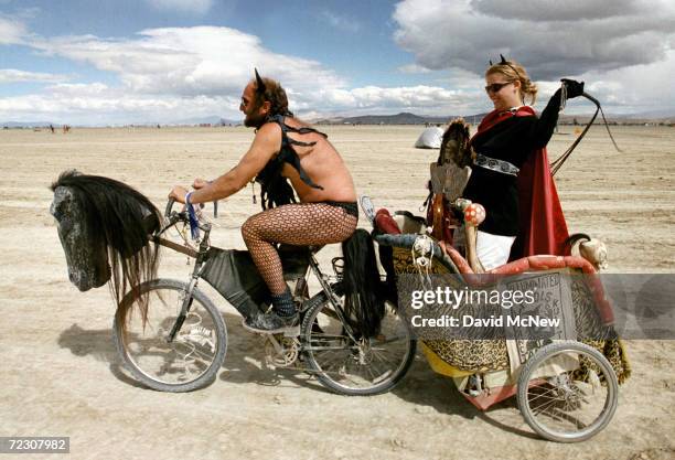 Dominating woman gets a chariot ride across the playa during the15th annual Burning Man festival September 2, 2000 in the Black Rock Desert near...