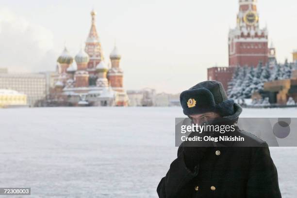 Russian police officer, braving the bitter cold, patrols Red Square with the Kremlin in the background January 7, 2003 in Moscow. Temperatures fell...