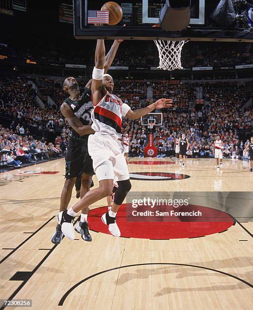 Guard Bonzi Wells of the Portland Trail Blazers shoots the ball as forward Joe Smith of the Minnesota Timberwolves attempts to block during the NBA...