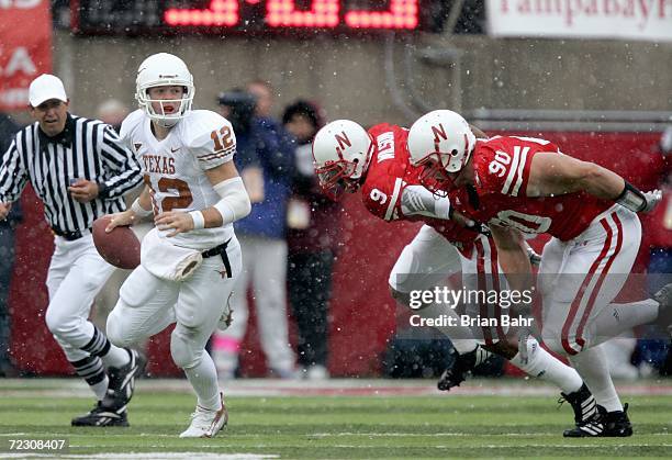 Bryan Wilson and Adam Carriker of the Nebraska Cornhuskers move to sack quarterback Colt McCoy of the Texas Longhorns on October 21, 2006 at Memorial...