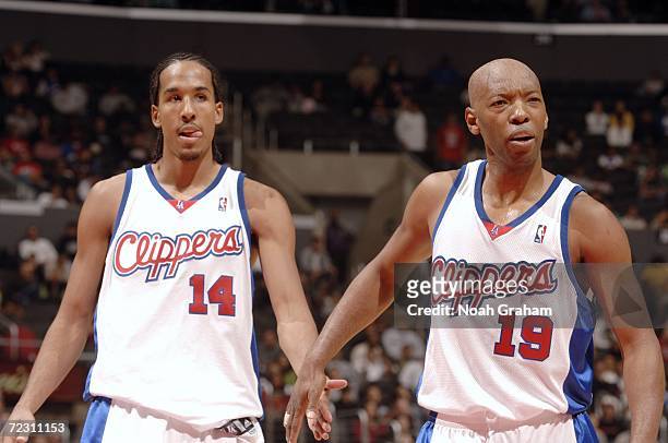 Shaun Livingston and Sam Cassell of the Los Angeles Clippers react to a play during a preseason game against the Portland Trail Blazers on October...